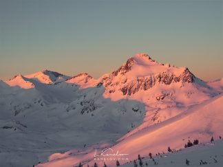 Winter sunset over a snow covered mountain